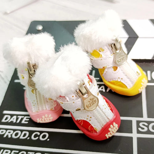 Pet snow boots with white fluffy cuffs, gold buckles, red and yellow soles, dotted upper