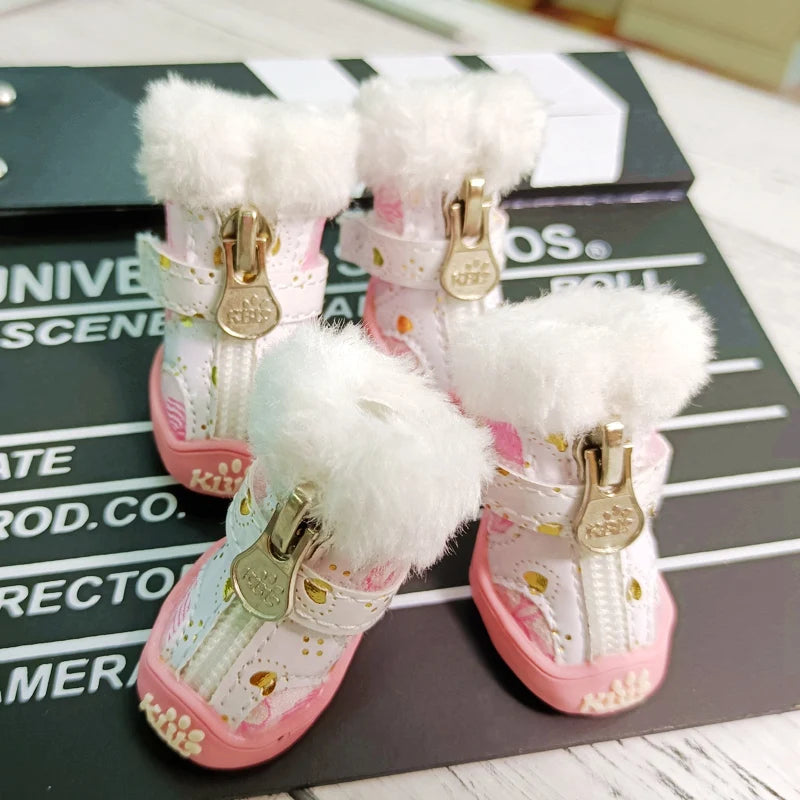 Pet snow boots set with white fluffy cuffs, gold buckles, pink soles, paw print detailing