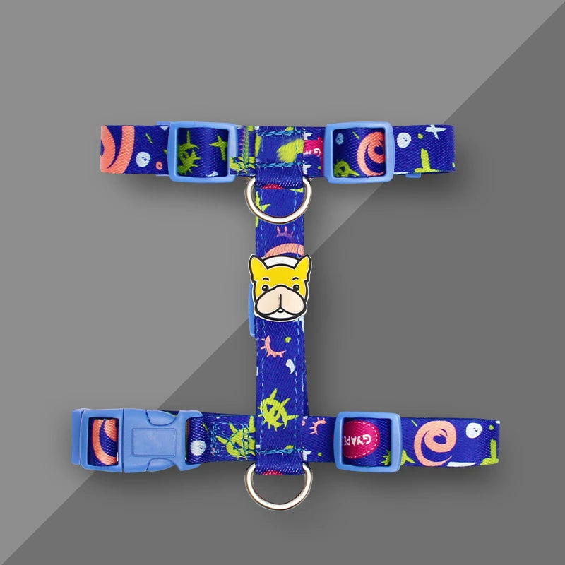 Blue dog harness vest with colorful graphic patches, round leash ring, adjustable blue buckle