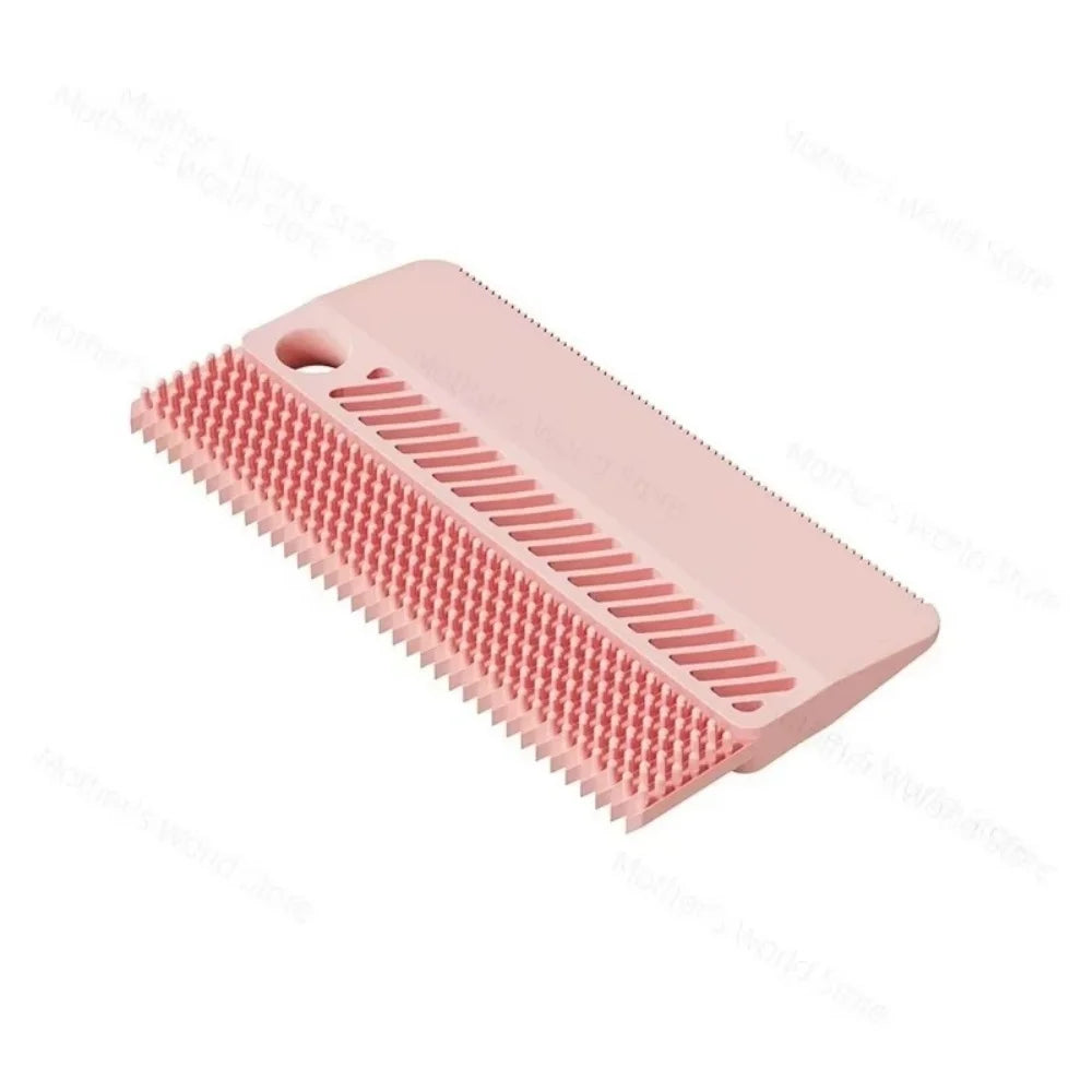 Pink pet hair removal brush with red bristle pads and comb-style scraper slots