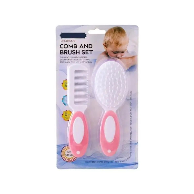 Infant comb and brush set with pink handles, white comb, and white oval brush pad