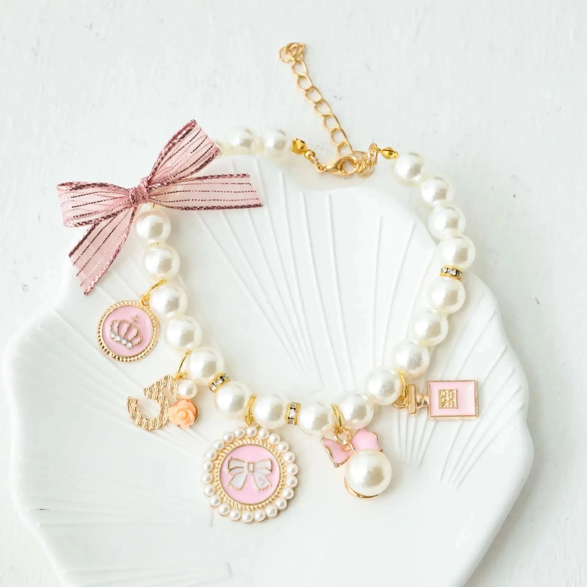 Pearl pet collar with pink lace bow and charm pendants, white beads