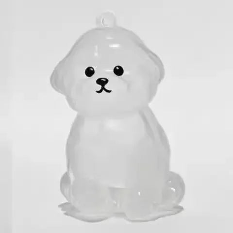 White resin dog charm keychain with black facial features