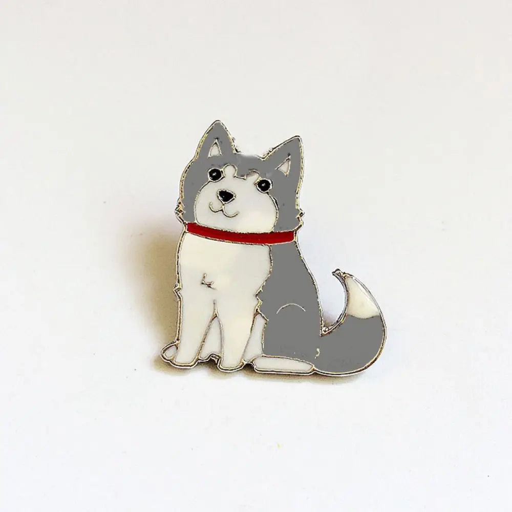 Enamel pin of a sitting gray and white cartoon dog with a red collar