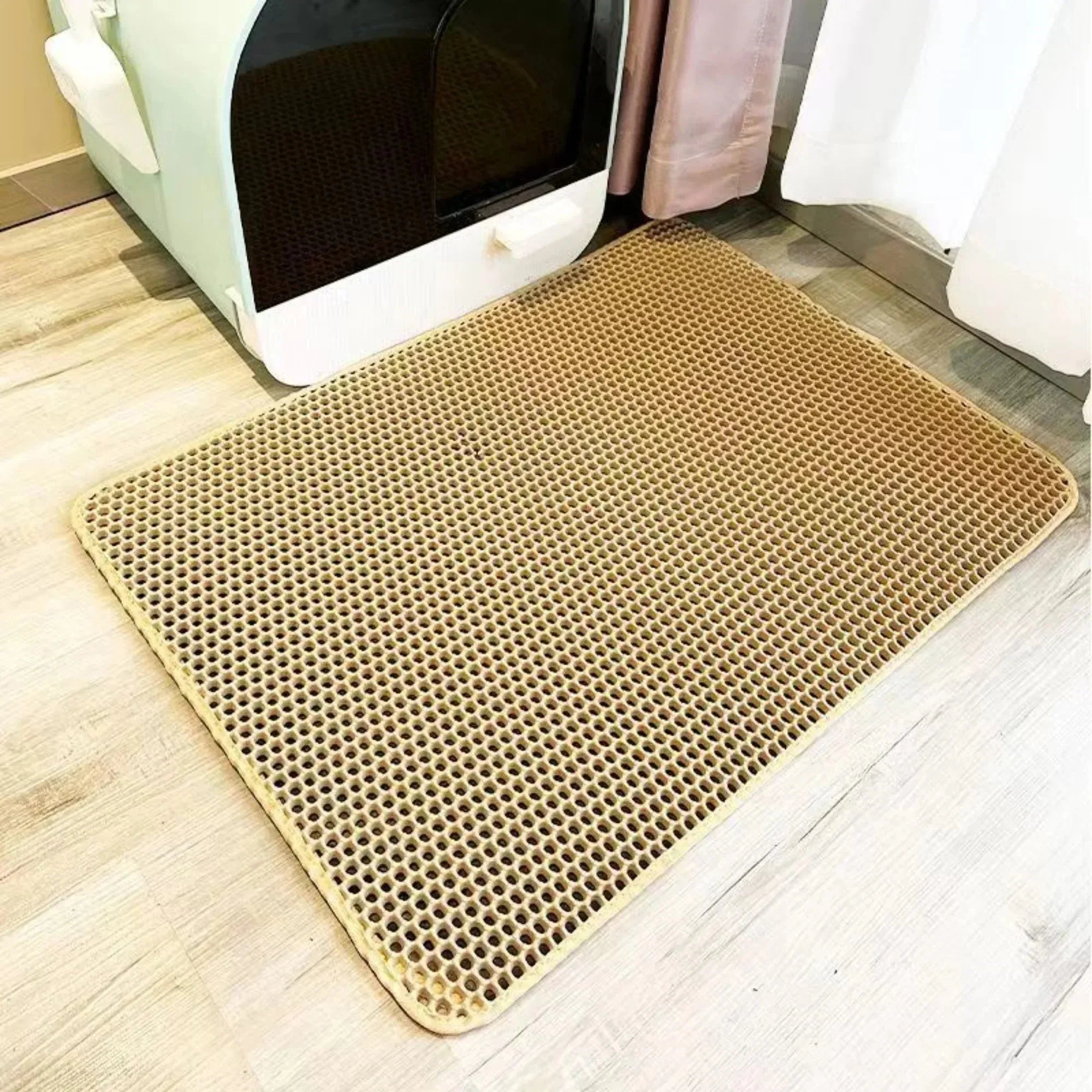 Yellow cat litter mat with raised honeycomb holes and rounded edges