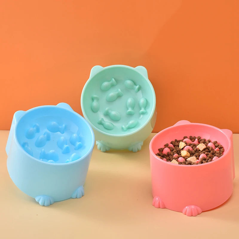 Slow feeder pet bowl set with raised paw feet, blue, mint, and pink with kibble