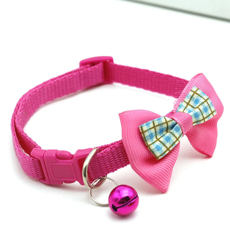 Pink cat collar with large check plaid bow and round bell charm