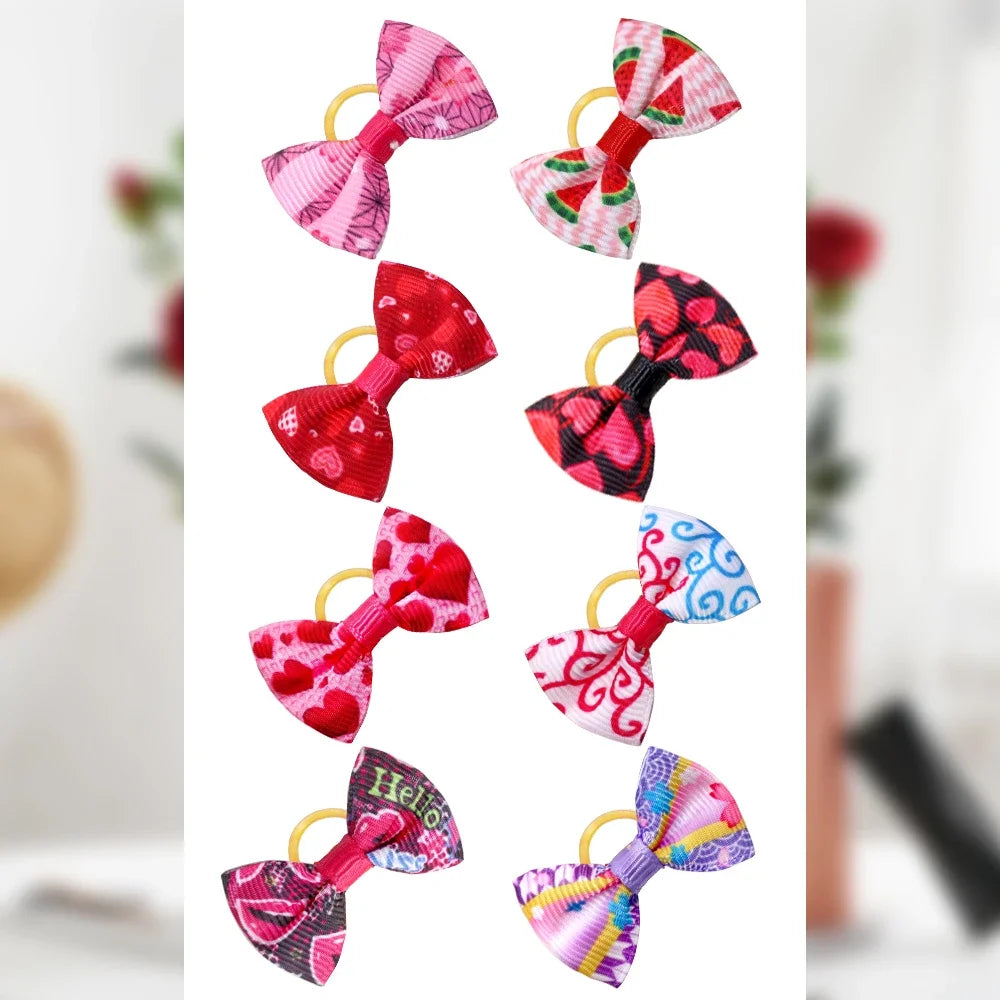 Red and pink patterned dog hair bows with gold elastic loops, assorted colors