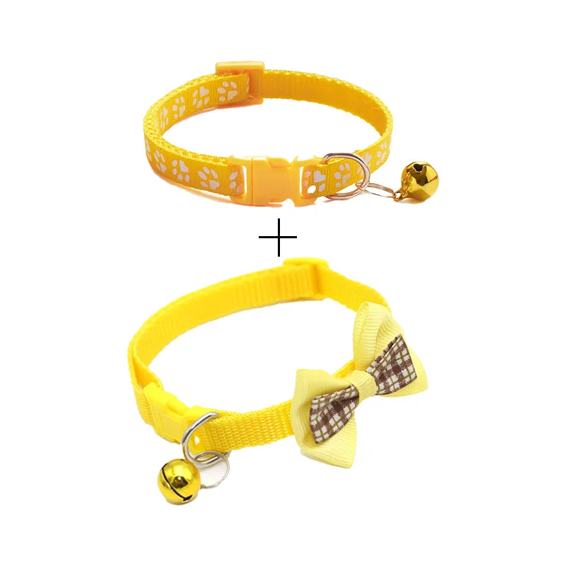 Yellow cat collar with bow and bell; paw-print fabric with plastic buckle