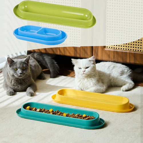 15-degree slanted pet feeder bowls in yellow, green, and blue on a floor