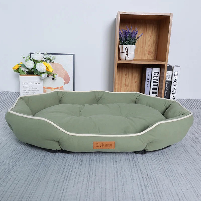 Large plush sofa bed for pets, sage green cushion with white piping and rounded sides