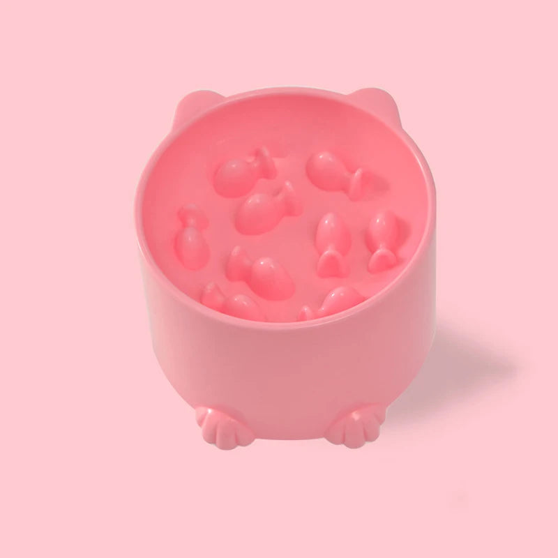 Pink slow feeder pet bowl with paw feet and textured puzzle insert, close-up
