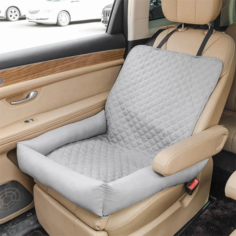 Pet car seat bed cover in light gray quilt pattern with padded cushion on a car seat.