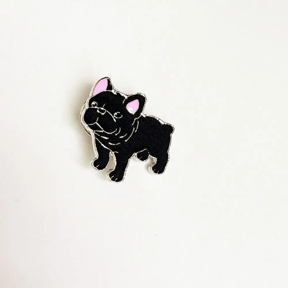 Black cartoon dog enamel pin with white muzzle and pink inner ears