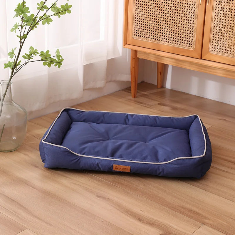 Navy blue plush pet sofa bed with white piping and padded rim