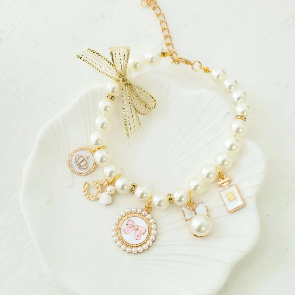 Pearl pet collar with gold lace bow and gold charm pendants, white beads