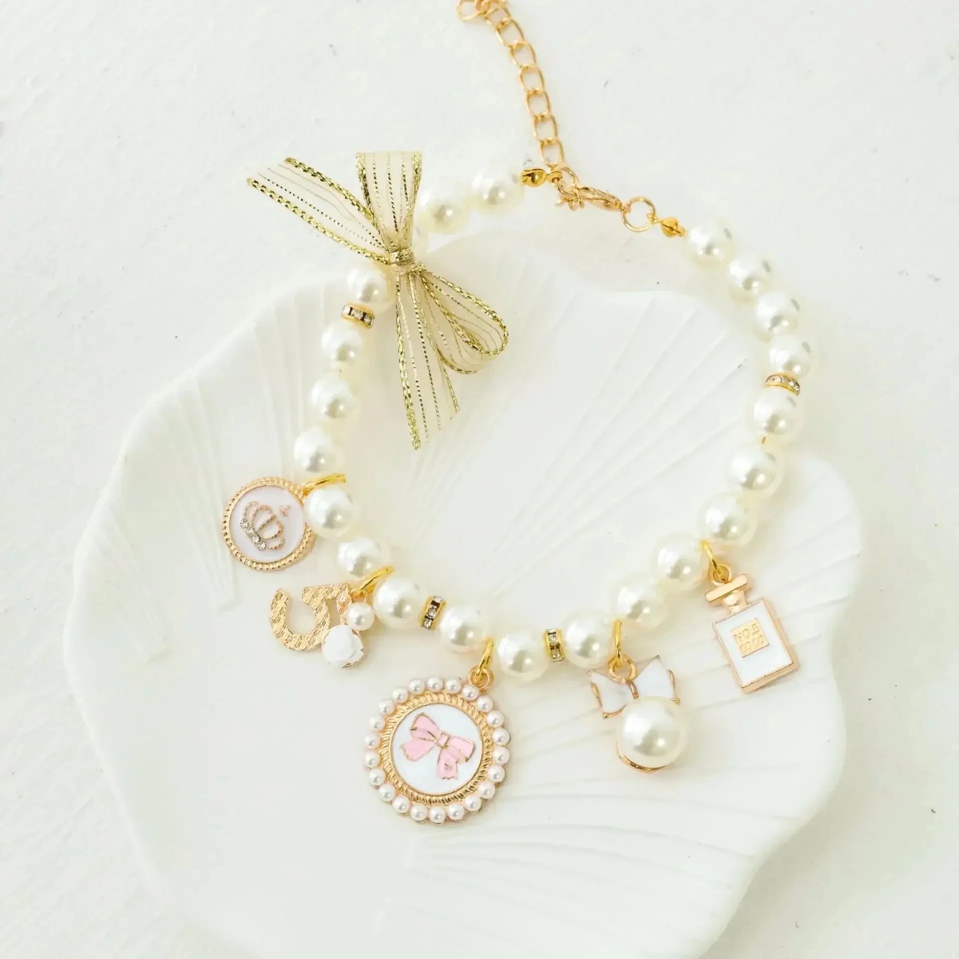 Pearl pet collar with gold lace bow and gold charm pendants, white beads