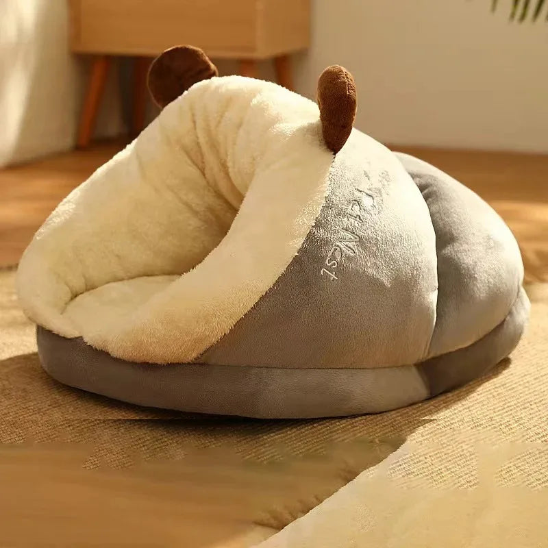 Cream and light gray dog bed mattress cushion with plush hood, dog resting inside.