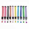 Assorted cat collars with bells, black cat-shaped holders and round bell charms
