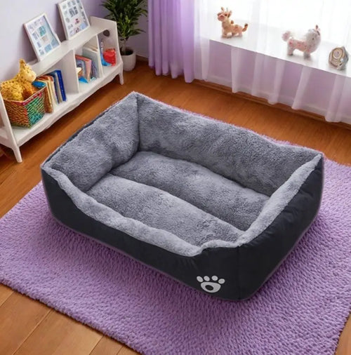 Plush dog bed with gray inner cushion and dark base, raised sides, paw logo front