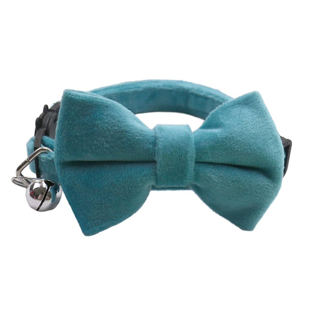 Velvet cat collar with bow tie and bell, teal bowknot close-up with silver bell