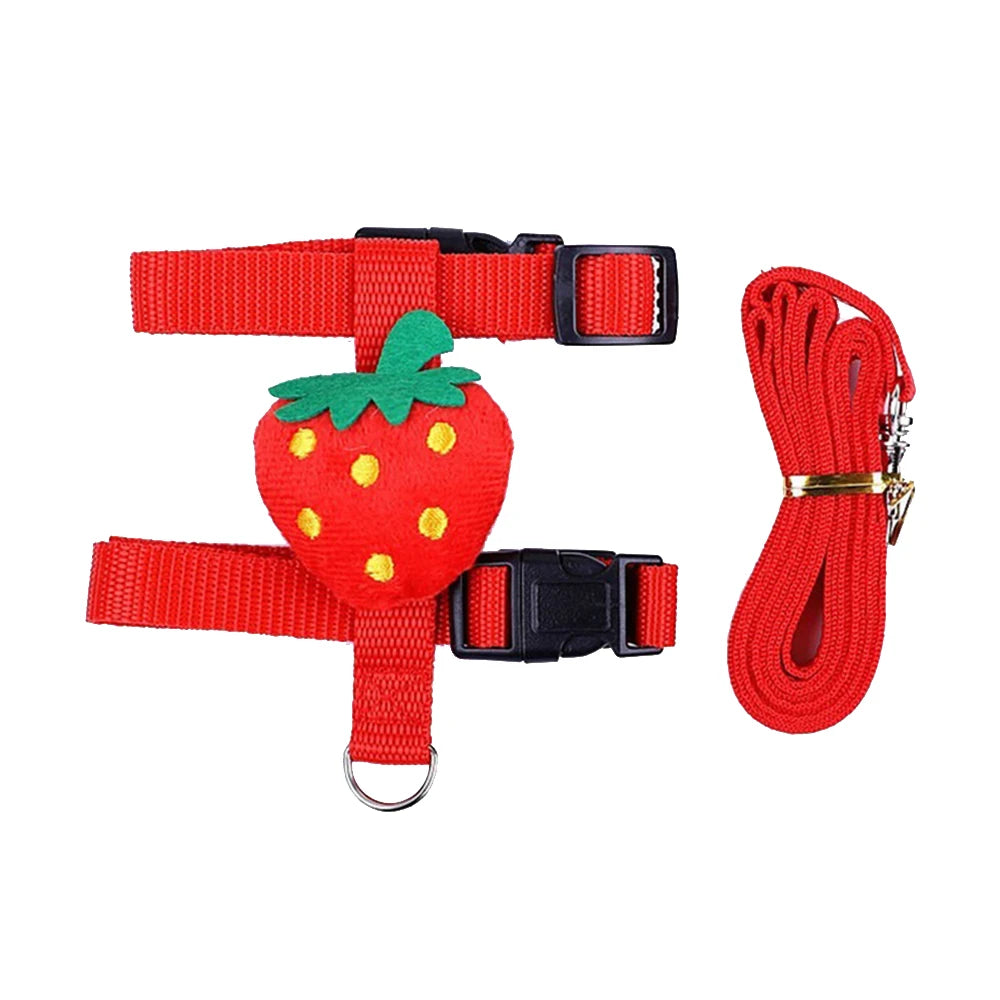 Adjustable pet harness and leash set with red strawberry plush design, black buckles, matching leash.