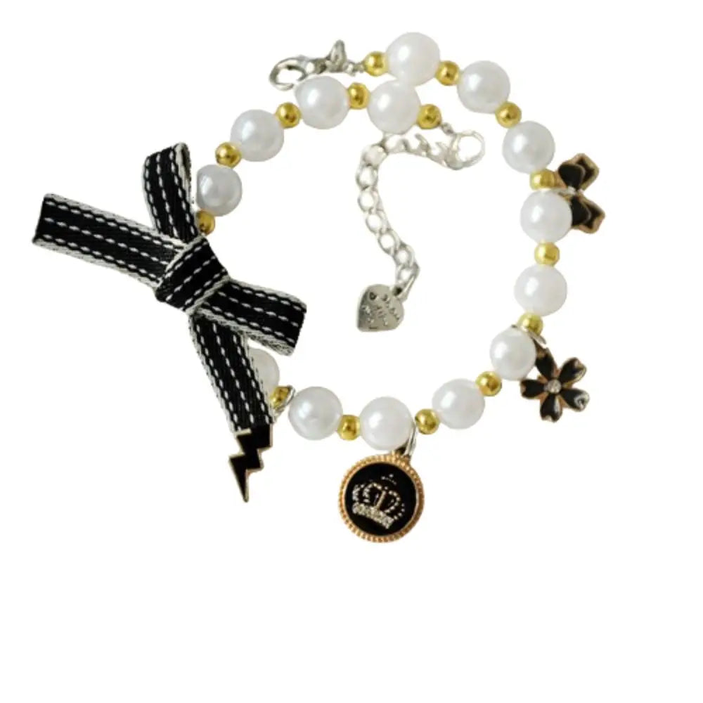 Cat pearl necklace collar with white beads, black ribbon bow, gold accents, heart pendant