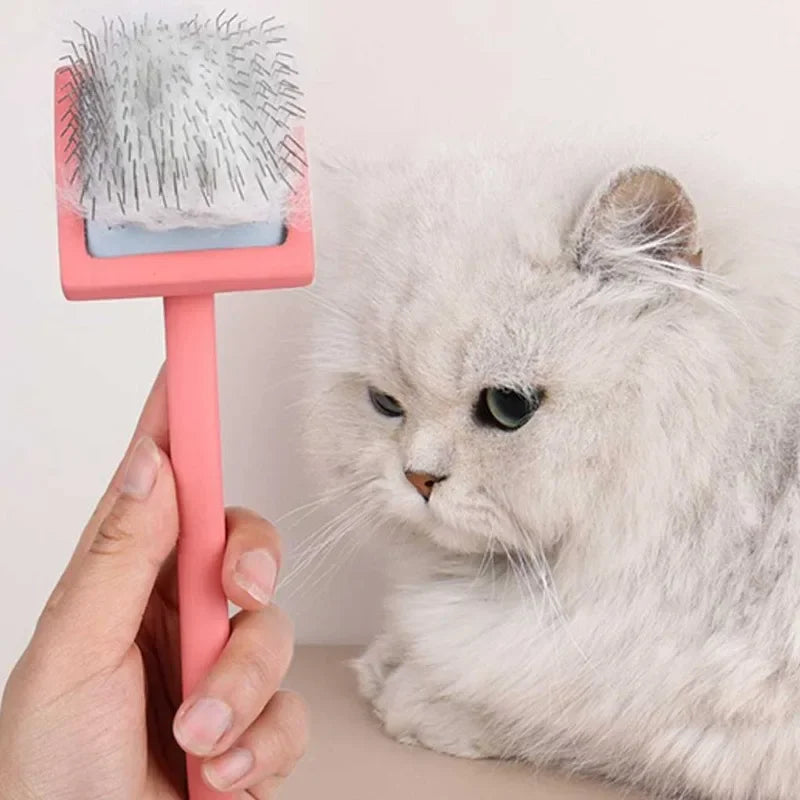 Red-handled double-sided pet grooming brush with silver metal deshedding pins