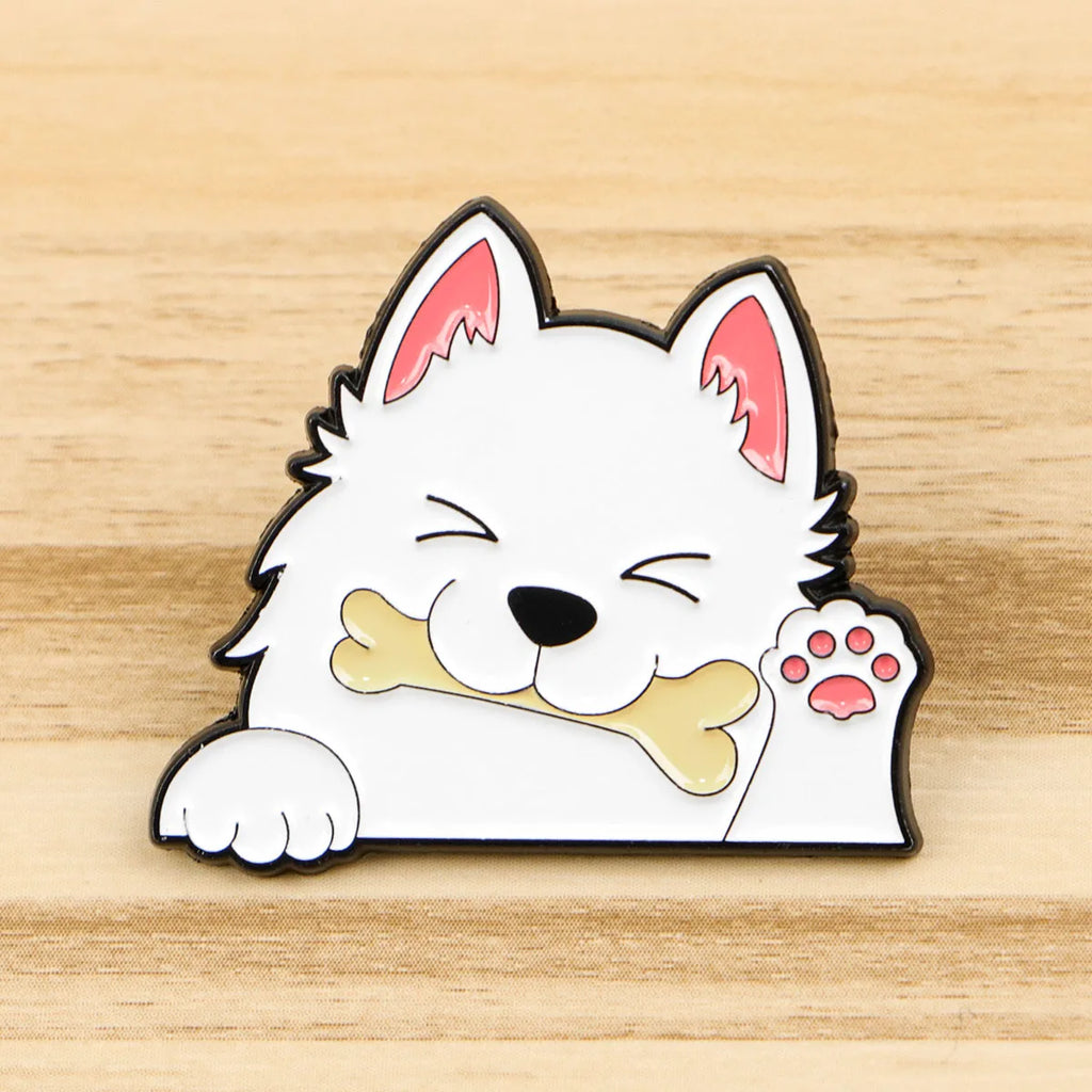 White dog enamel lapel pin lying down with bone and pink paw-print detail