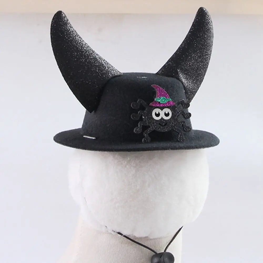 Black pet cosplay hat with horn points and witch cat emblem; chin strap.