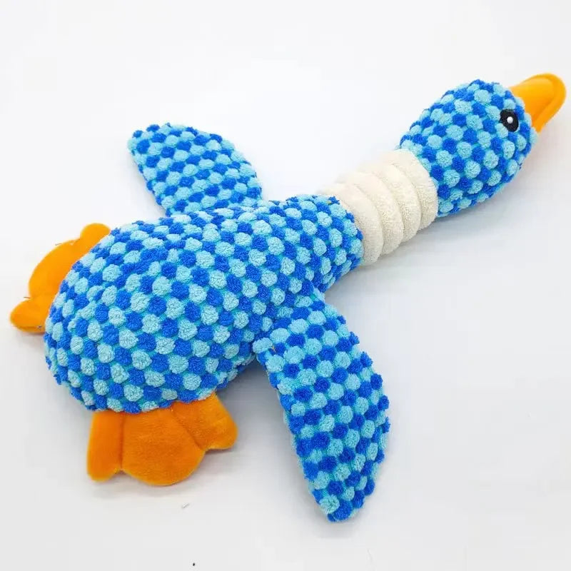 Close-up of blue dotted plush fish chew toy with orange fins and white belly band