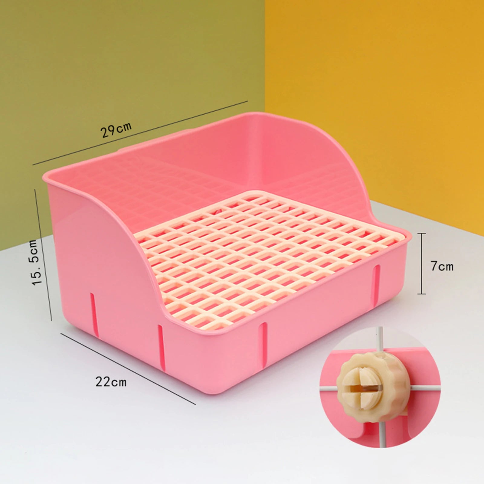Small animal litter box with pink frame and white mesh tray, corner tabs shown