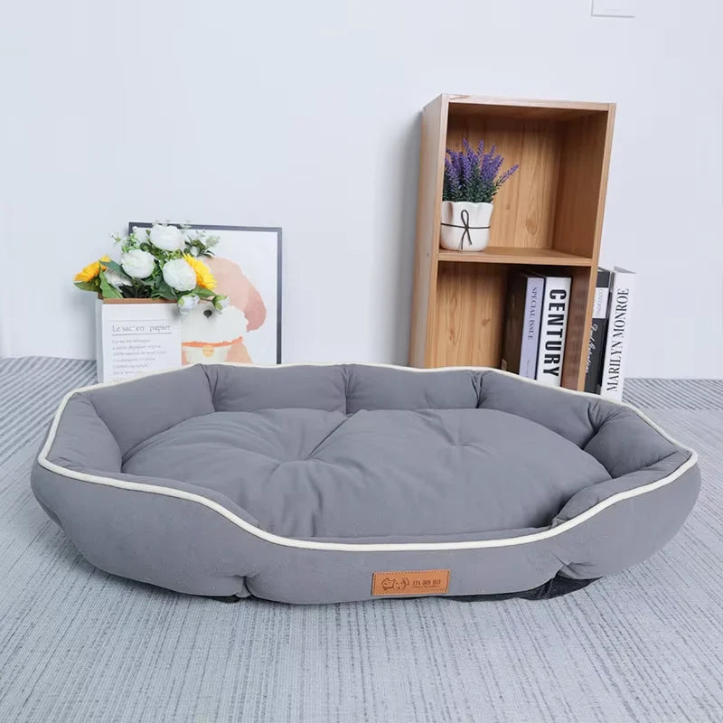 Gray plush pet sofa bed with white piping and rounded bolster sides