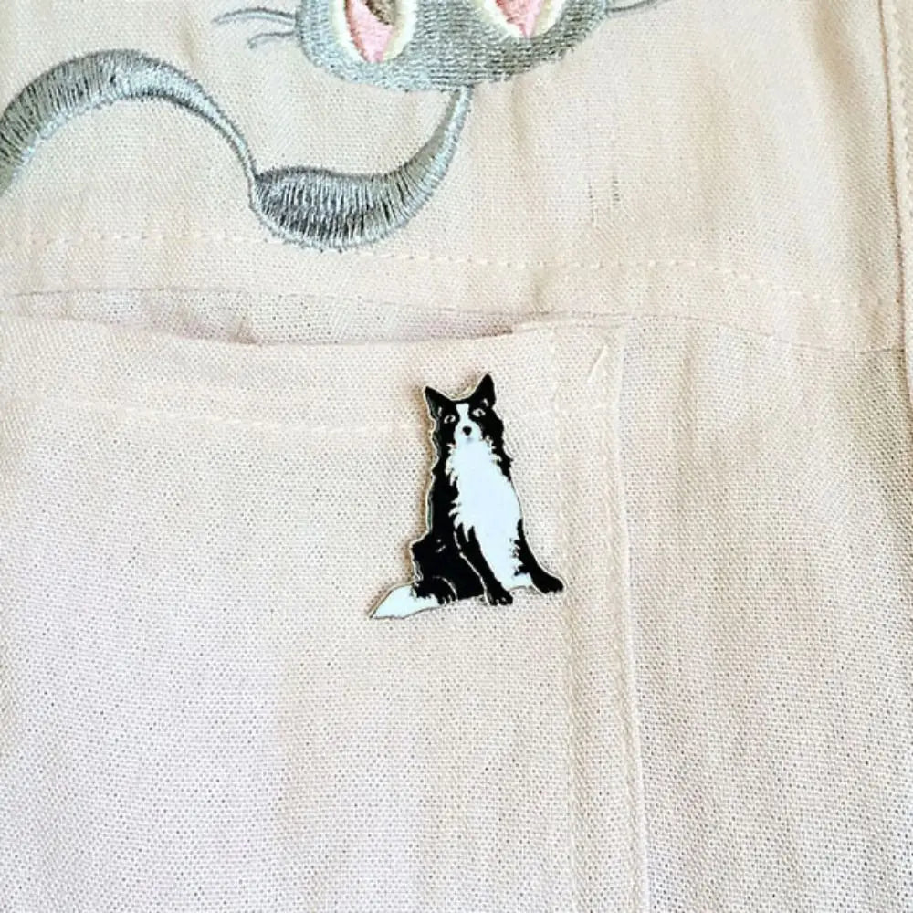 Black and white cartoon husky enamel pin on light fabric