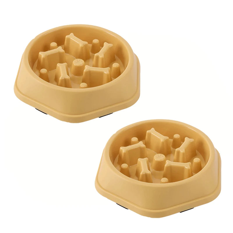 Two tan non-slip slow feeder dog bowls with raised maze ridges and studs