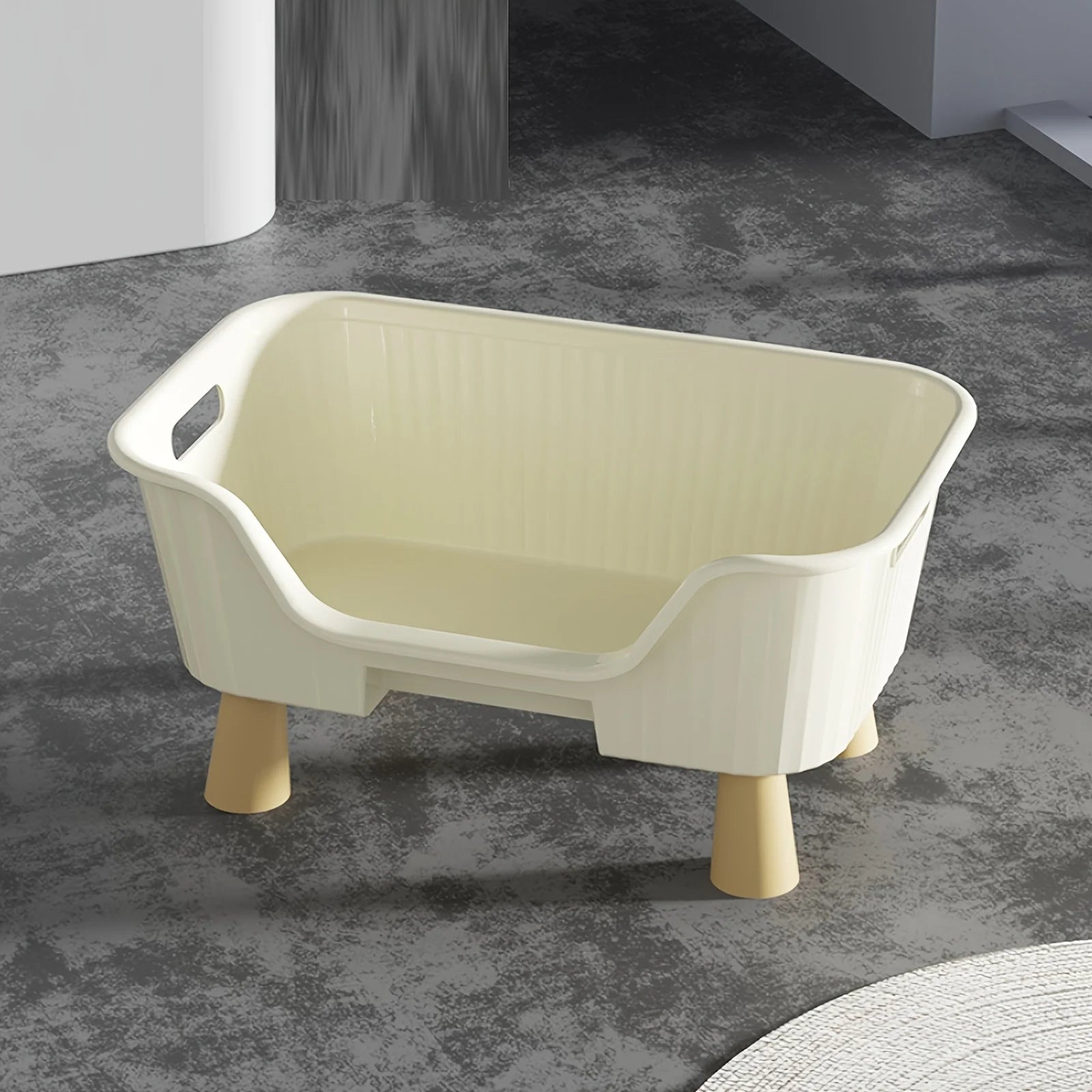 White cat bed with cream inner lining, raised sides, and front opening, on tan legs.