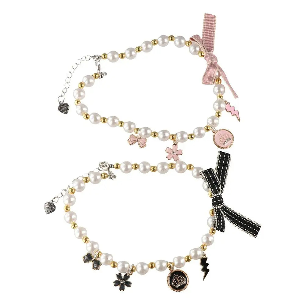 Cat pearl necklace collar with pink ribbon bow and heart, flower, and bolt charms