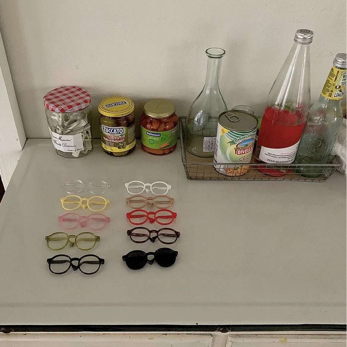 Pet novelty sunglasses set with assorted frame colors arranged on a shelf