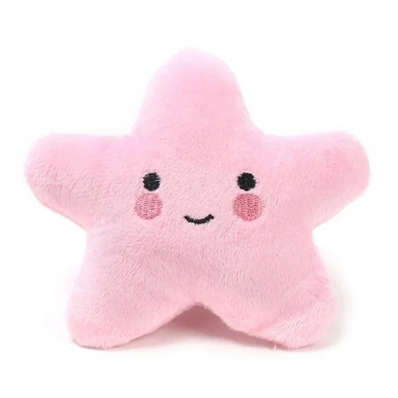 Squeaky plush pentagram pet toy in pink star shape with smiling face and rosy cheek dots.