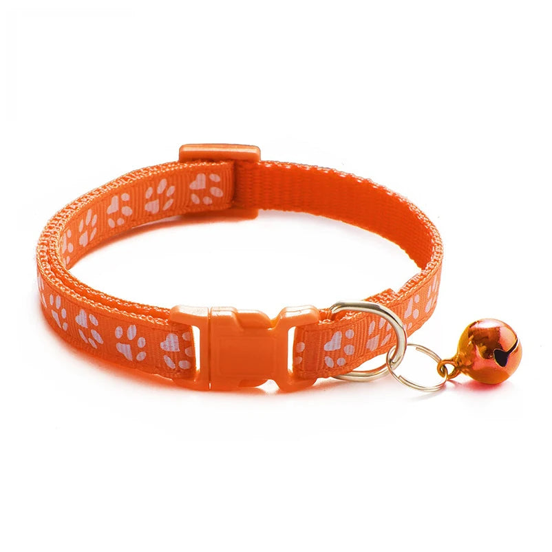 Orange paw-print cat collar with buckle and round copper bell