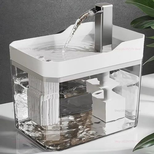 Automatic pet drinking fountain with white top, clear tank, and water pouring from spout