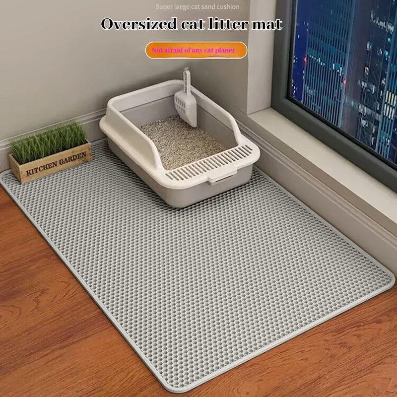 Oversized light gray cat litter mat with honeycomb texture covering the floor area