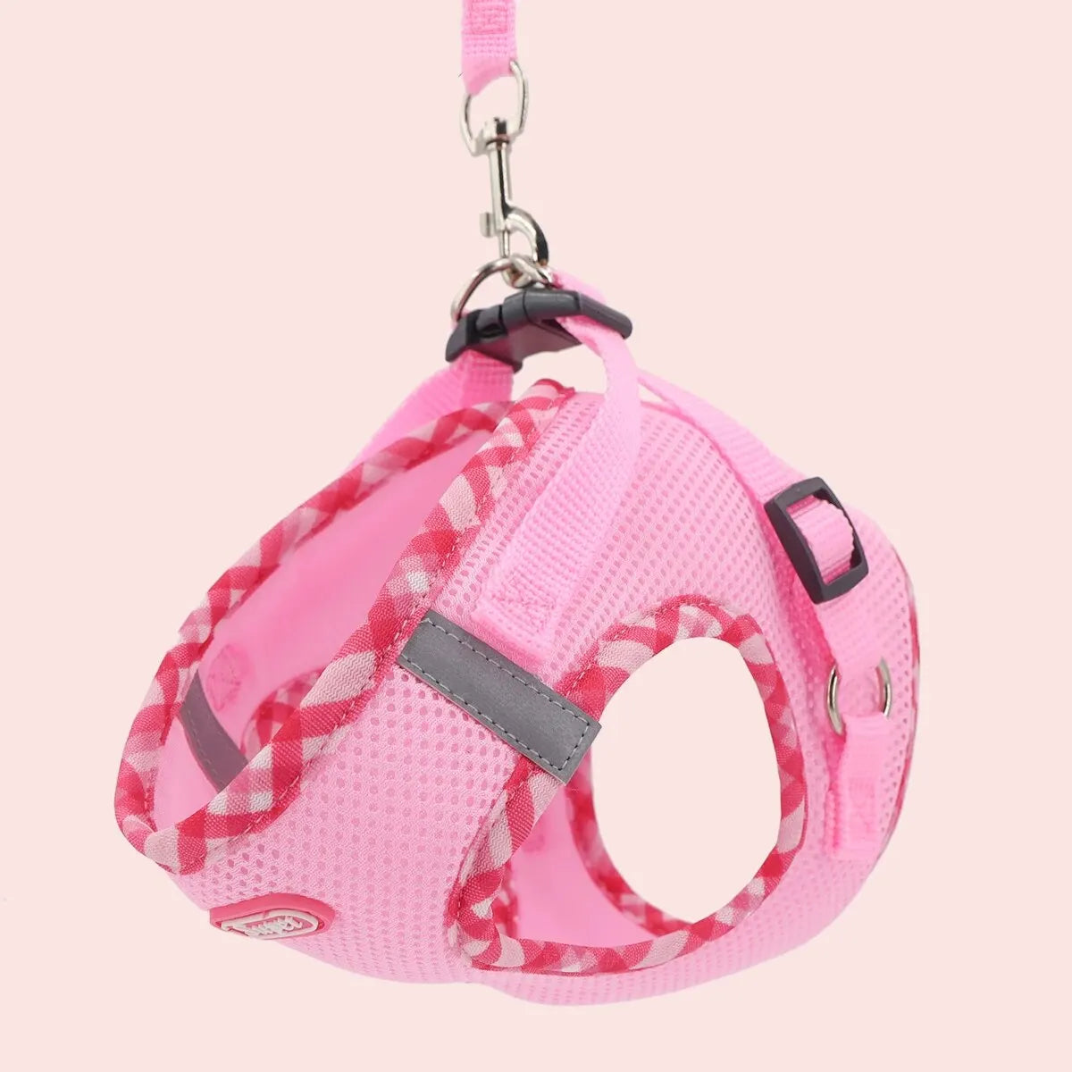 Pink plaid adjustable dog harness with leash attachment and metal clasp