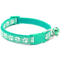 Adjustable cat collar in teal with white paw prints, bell and adjustable buckle