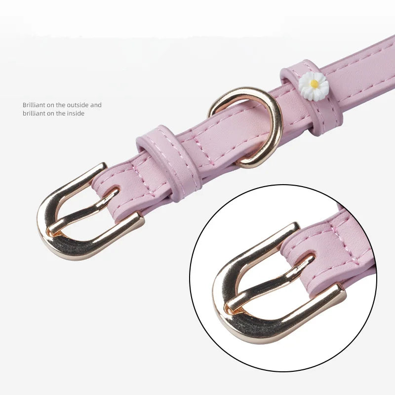 Pink PU leather pet collar with daisy accents and alloy buckle; close-up view
