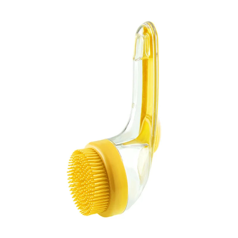 Yellow silicone pet grooming brush with raised tip pad and curved clear handle