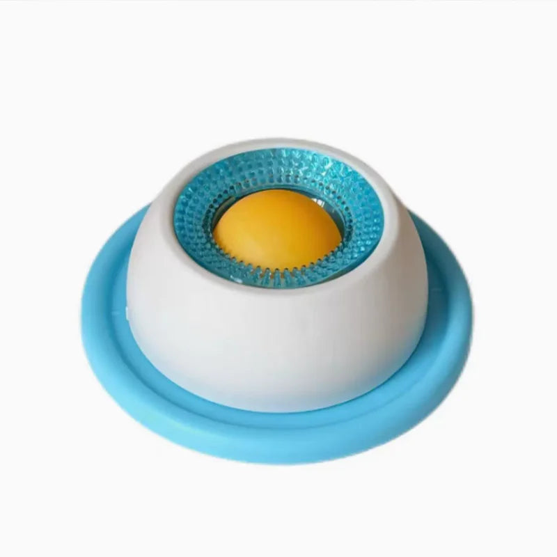 Pet licking puzzle toy with blue base, white dome, teal textured rim, and orange insert