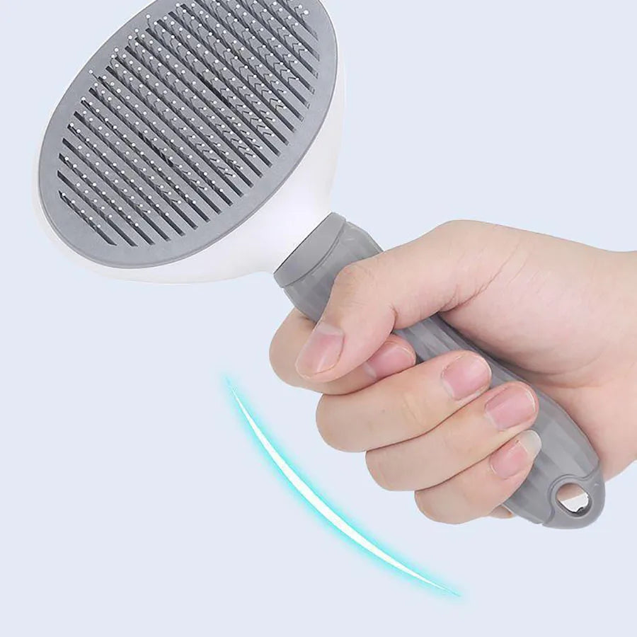 Grey dog grooming brush with pin comb head and molded easy-clean button handle