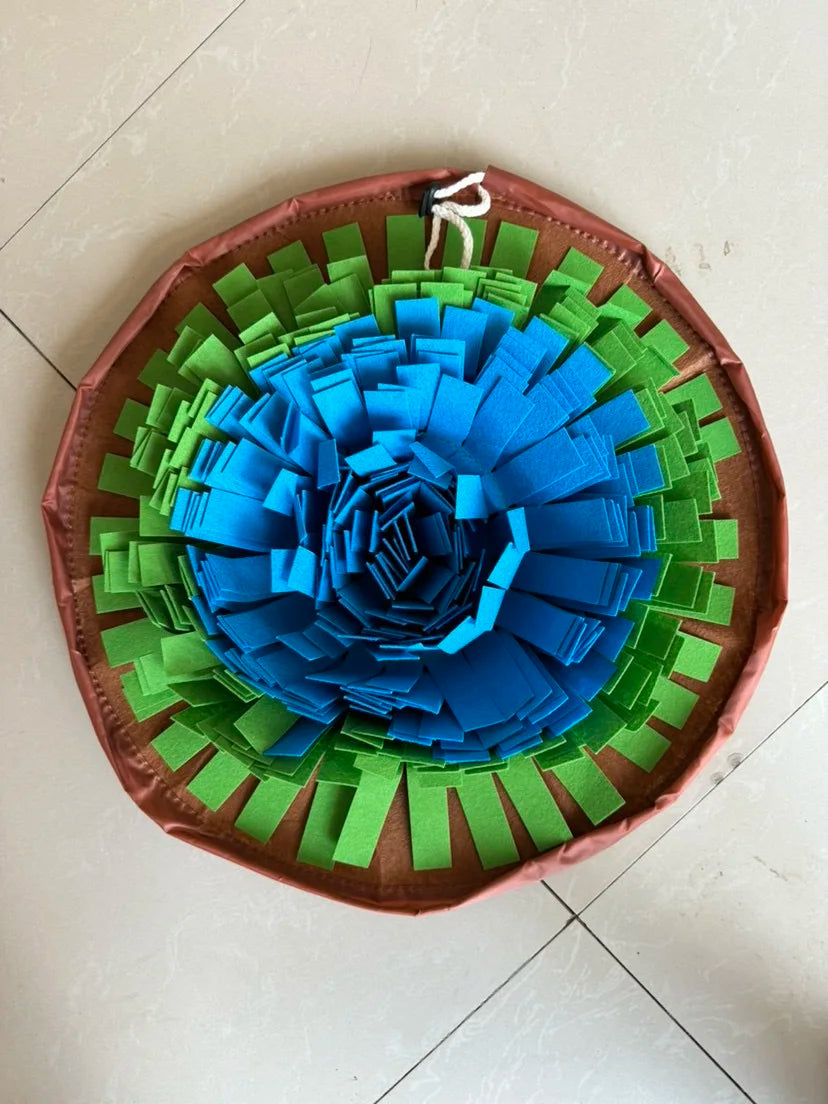 Pet snuffle mat for dogs and cats, circular mat with blue, green, and brown foraging strips.