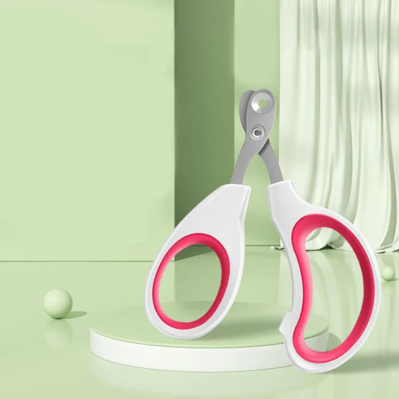Pet nail trimmer scissors with circular safety hole, white handles and pink ring accents